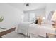 Bright bedroom with white walls, wood floors, and a cozy bed with decorative pillows at 415 French St, Charlotte, NC 28216