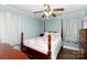 Bedroom featuring a wooden frame bed with a floral quilt, ceiling fan, and a light blue painted walls at 427 Spencer St, Rock Hill, SC 29730