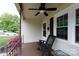 Cozy front porch with a ceiling fan, wooden bench, and flowering bushes at 427 Spencer St, Rock Hill, SC 29730