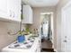 Laundry room featuring storage cabinets, washer and dryer, and access to the water heater closet at 427 Spencer St, Rock Hill, SC 29730