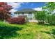 Spacious backyard featuring green lawn and mature trees, creating a serene and private outdoor retreat at 4333 Sawmill Trace Dr, Charlotte, NC 28213