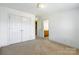 This bedroom features neutral walls, neutral carpet and closet doors at 4333 Sawmill Trace Dr, Charlotte, NC 28213