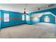 The bedroom features vibrant blue walls with an orange stripe, a ceiling fan, and white windows at 4333 Sawmill Trace Dr, Charlotte, NC 28213