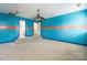 The bedroom features vibrant blue walls, an orange stripe and neutral carpet at 4333 Sawmill Trace Dr, Charlotte, NC 28213
