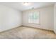 This bedroom has a window with white blinds and a neutral carpet at 4333 Sawmill Trace Dr, Charlotte, NC 28213