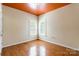 Bedroom with hardwood floors, two windows, and neutral paint at 4333 Sawmill Trace Dr, Charlotte, NC 28213