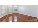 Bright room featuring hardwood floors, natural light, and shuttered windows at 4333 Sawmill Trace Dr, Charlotte, NC 28213