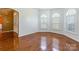 Sun-filled room with hardwood floors, arched windows, and neutral wall paint at 4333 Sawmill Trace Dr, Charlotte, NC 28213