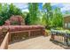 This deck has a BBQ and mature trees and shrubbery in the back yard at 4333 Sawmill Trace Dr, Charlotte, NC 28213