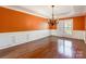 Elegant dining room featuring a striking chandelier, hardwood floors, and wainscoting details at 4333 Sawmill Trace Dr, Charlotte, NC 28213