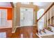 Inviting foyer with hardwood floors, staircase, and natural light streaming through the front door at 4333 Sawmill Trace Dr, Charlotte, NC 28213