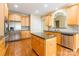 Kitchen with stainless steel appliances, wooden cabinets, and an island, creating a stylish and functional cooking space at 4333 Sawmill Trace Dr, Charlotte, NC 28213
