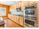 Stainless steel oven and microwave give this kitchen with hardwood floors an elegant appeal at 4333 Sawmill Trace Dr, Charlotte, NC 28213
