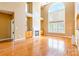 Bright living room with hardwood floors, fireplace, and large windows filling the space with natural light at 4333 Sawmill Trace Dr, Charlotte, NC 28213