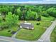 Picturesque aerial view of a charming single-story home with a long driveway and mature trees at 4462 Flat Creek Rd, Heath Springs, SC 29058
