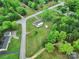 Aerial view displays the property surrounded by lush greenery, roads and neighboring houses at 4462 Flat Creek Rd, Heath Springs, SC 29058