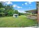 Large backyard featuring a storage shed and a covered porch with a view of the wooded area at 4462 Flat Creek Rd, Heath Springs, SC 29058