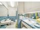 Well-lit bathroom with blue tiling and mirrored cabinets providing storage at 4462 Flat Creek Rd, Heath Springs, SC 29058