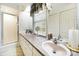 Bright bathroom featuring dual sinks, a walk-in shower, and overhead cabinets at 4462 Flat Creek Rd, Heath Springs, SC 29058