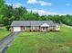 Beautifully landscaped front yard with a classic brick home and attached garage at 4462 Flat Creek Rd, Heath Springs, SC 29058