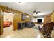 Spacious living room featuring wood paneling, ceiling fan, and access to a bedroom at 4462 Flat Creek Rd, Heath Springs, SC 29058