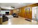 Comfortable living room with wood paneling, ceiling fan, and ample seating at 4462 Flat Creek Rd, Heath Springs, SC 29058