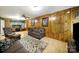 Cozy living room features wood paneling, ample seating, and a ceiling fan at 4462 Flat Creek Rd, Heath Springs, SC 29058