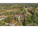 Expansive aerial view of the home, its landscaped grounds, and surrounding lush greenery at 5016 Woodwinds Ne Dr, Hickory, NC 28601