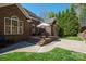 Charming backyard patio with brick steps, an umbrella, and manicured lawn, creating a perfect outdoor retreat at 5016 Woodwinds Ne Dr, Hickory, NC 28601