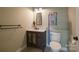 Well-lit half bathroom featuring a sleek vanity, modern fixtures, and a toilet at 5016 Woodwinds Ne Dr, Hickory, NC 28601