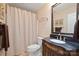 Bathroom with a dark vanity, toilet, shower with curtain and neutral color scheme at 5016 Woodwinds Ne Dr, Hickory, NC 28601