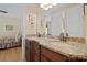 Bathroom vanity with dual sinks, granite countertops, and wood cabinetry at 5016 Woodwinds Ne Dr, Hickory, NC 28601