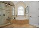 Luxurious bathroom with a separate shower and tub, tile surround, and natural light at 5016 Woodwinds Ne Dr, Hickory, NC 28601