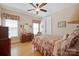 Bedroom featuring hardwood floors, floral accents, and natural light at 5016 Woodwinds Ne Dr, Hickory, NC 28601