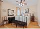 Cozy bedroom with a ceiling fan, hardwood floors, and natural light from a window at 5016 Woodwinds Ne Dr, Hickory, NC 28601