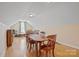 Spacious bonus room featuring wood floors, a window and a dining table set at 5016 Woodwinds Ne Dr, Hickory, NC 28601
