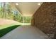 Covered patio featuring a brick wall, concrete floor, and access to the outdoors, creating an outdoor space at 5016 Woodwinds Ne Dr, Hickory, NC 28601
