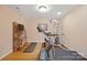 Bright exercise room featuring a treadmill, weight machine, and a display shelf, perfect for a home gym at 5016 Woodwinds Ne Dr, Hickory, NC 28601