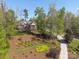 Beautiful home with detailed landscaping, mature trees, and a winding driveway leading to the property at 5016 Woodwinds Ne Dr, Hickory, NC 28601
