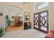Elegant foyer with travertine flooring, soaring ceilings, decorative doors, and views of the adjacent dining room at 5016 Woodwinds Ne Dr, Hickory, NC 28601