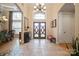 Grand foyer boasts high ceilings, decorative double doors, stone flooring, and abundant natural light at 5016 Woodwinds Ne Dr, Hickory, NC 28601