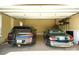 Spacious garage showcasing two parked vehicles with shelving, offering ample storage and parking space at 5016 Woodwinds Ne Dr, Hickory, NC 28601