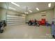Spacious garage featuring epoxy flooring, a motorcycle, tool chests, and a side door, perfect for storage and projects at 5016 Woodwinds Ne Dr, Hickory, NC 28601