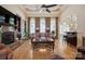 Inviting living room with a fireplace, hardwood floors, a comfortable leather sofa, and views into the kitchen at 5016 Woodwinds Ne Dr, Hickory, NC 28601