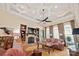 Cozy living room featuring a fireplace, built-in shelving, hardwood floors, and arched windows with custom curtains at 5016 Woodwinds Ne Dr, Hickory, NC 28601