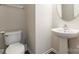 Half bathroom featuring a pedestal sink and toilet, providing convenience for guests at 523 Tribune Dr, Charlotte, NC 28214