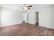 Spacious bedroom featuring wood-look flooring and two entry doors, offering versatility and comfort at 523 Tribune Dr, Charlotte, NC 28214