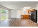 Open floorplan kitchen featuring wood cabinets, laminate countertops, stainless steel dishwasher and a slider door at 523 Tribune Dr, Charlotte, NC 28214
