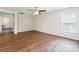 Open living area featuring hardwood floors, white walls, ceiling fan and a window with natural light at 523 Tribune Dr, Charlotte, NC 28214