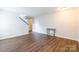 Bright living area showcasing wood floors, white walls, with a staircase and views into other rooms at 523 Tribune Dr, Charlotte, NC 28214